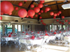 The reception hall is decorated in flowers and large balloons for a wedding