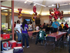 Guests attend a sports party at the teen center