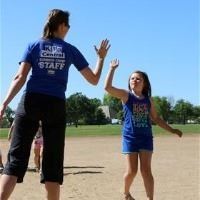 Child high fiving a staff member